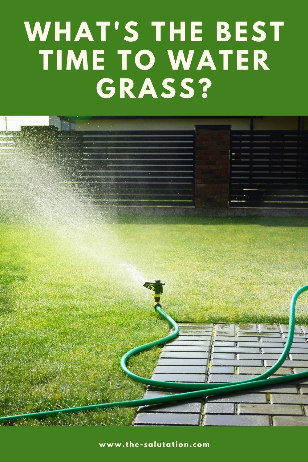 Image of a grass field with a running sprinkler in the background